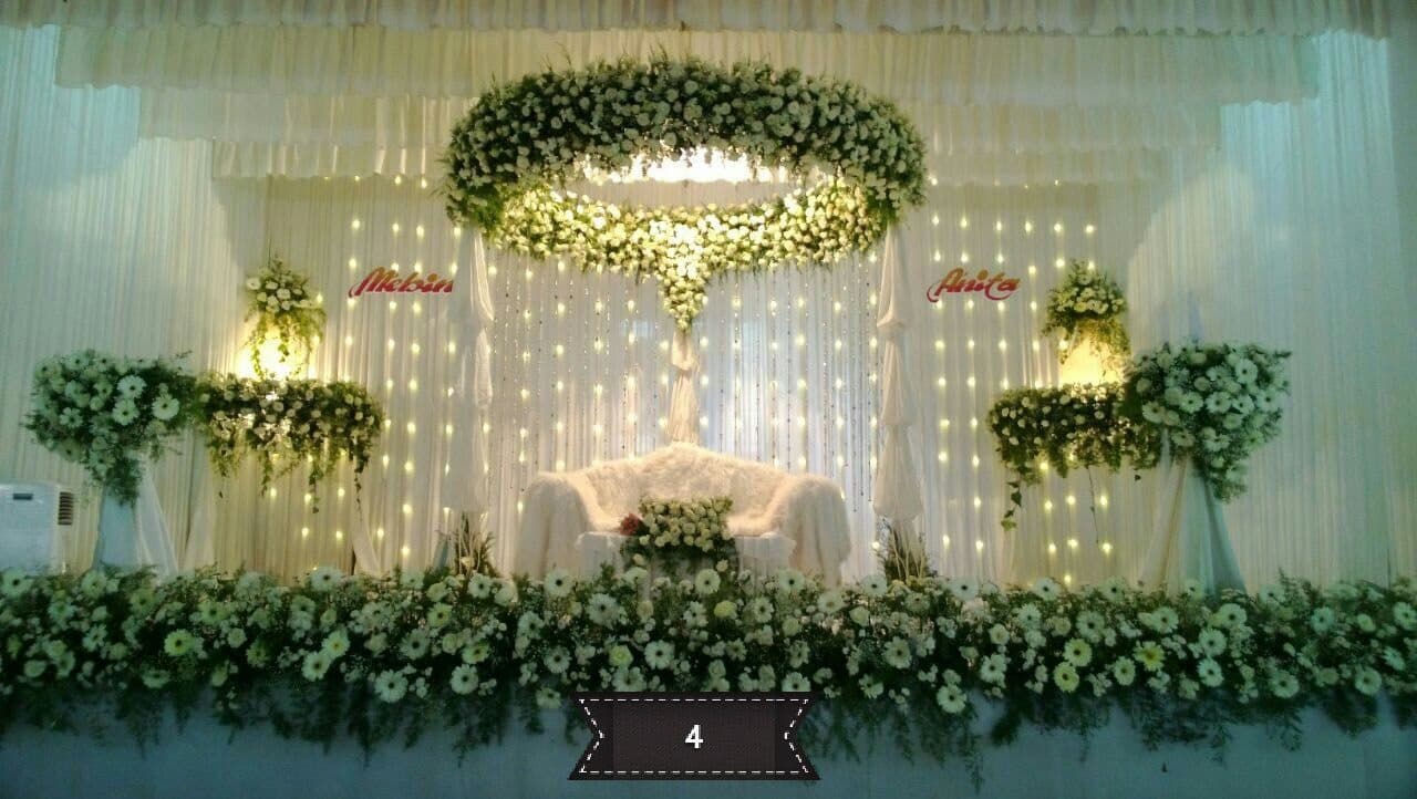 White and green floral wedding stage with hanging installations