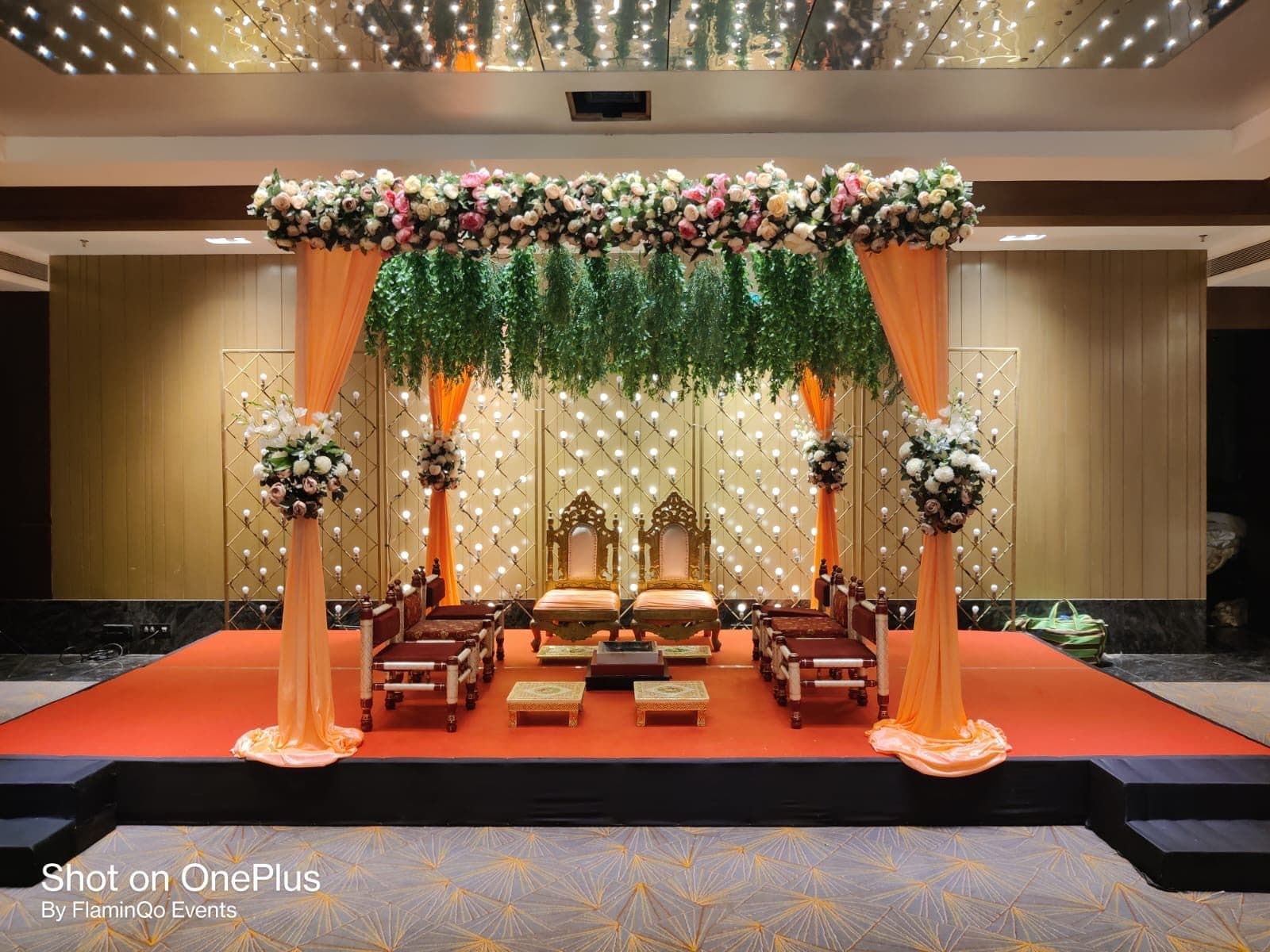 Traditional mandap with marigold garlands and a decorated seating platform