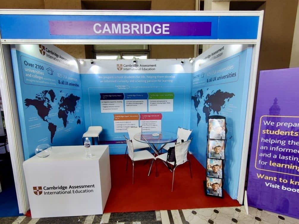 Cambridge Assessment exhibition booth with branded panels and meeting seating